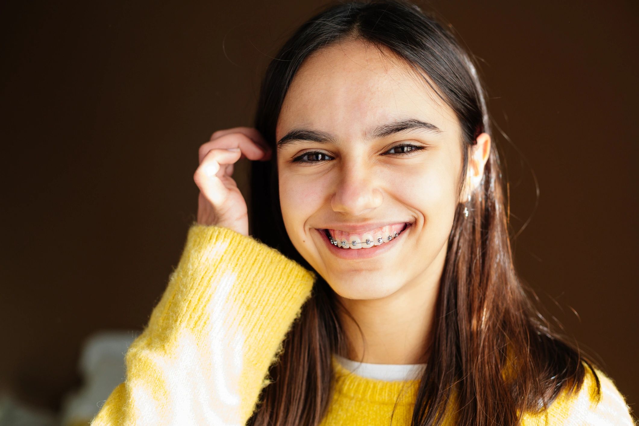 Teen patient with braces smiling confidently