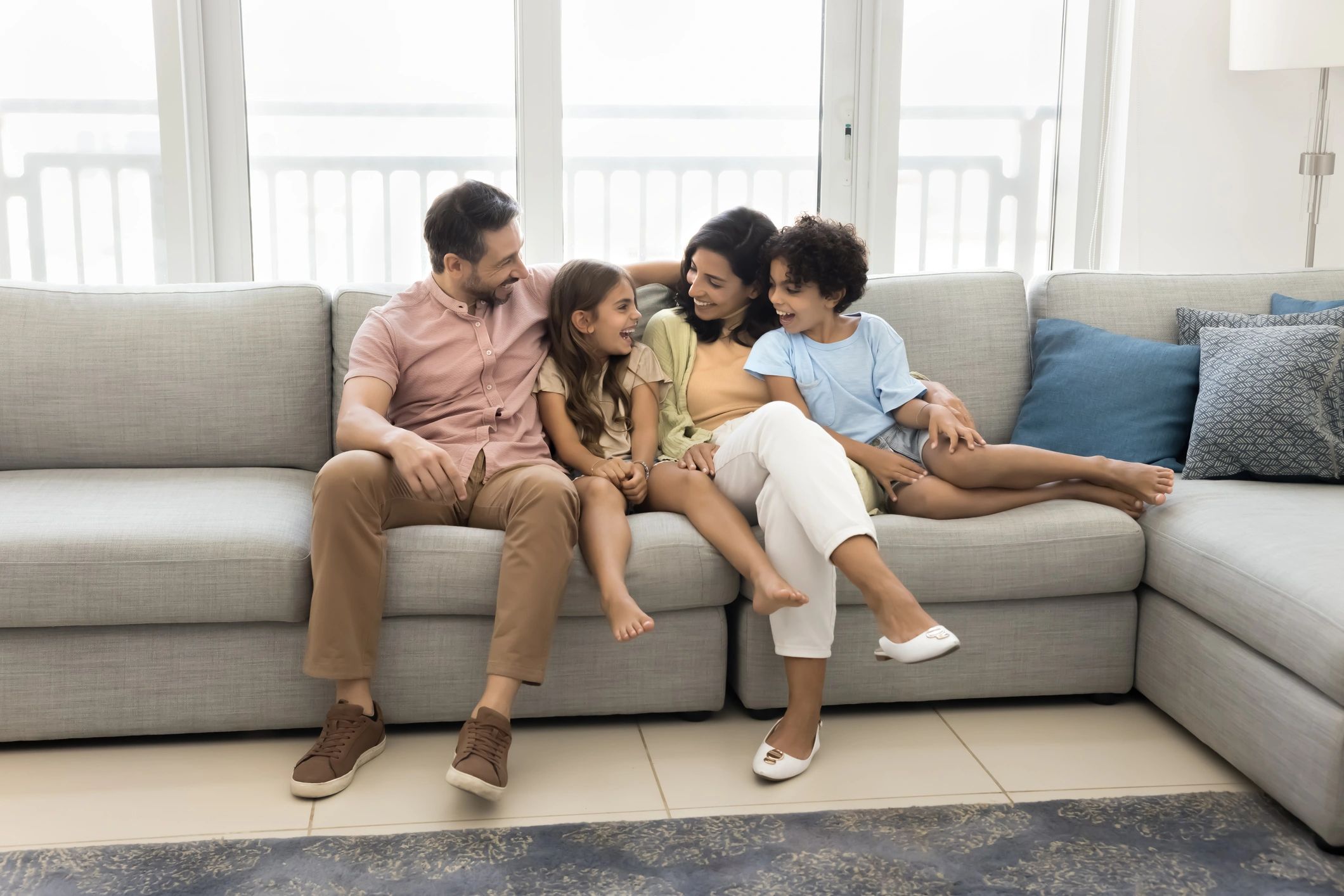 Parents and children smiling together in a relaxed family setting