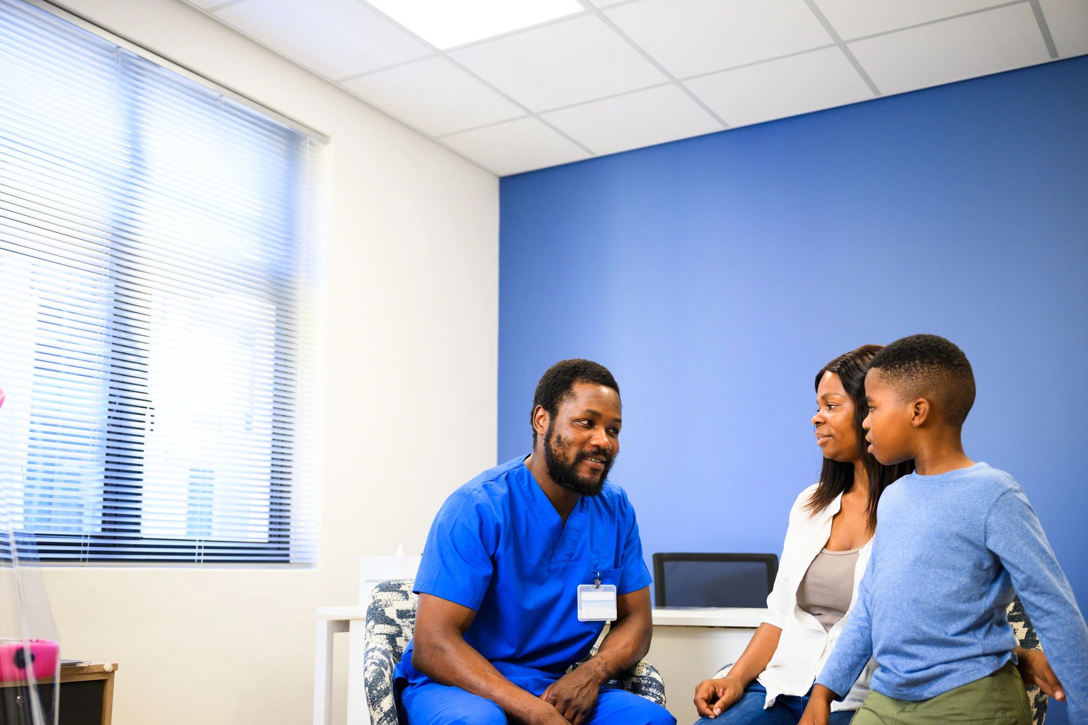 Parent and child meeting with a doctor in a modern office