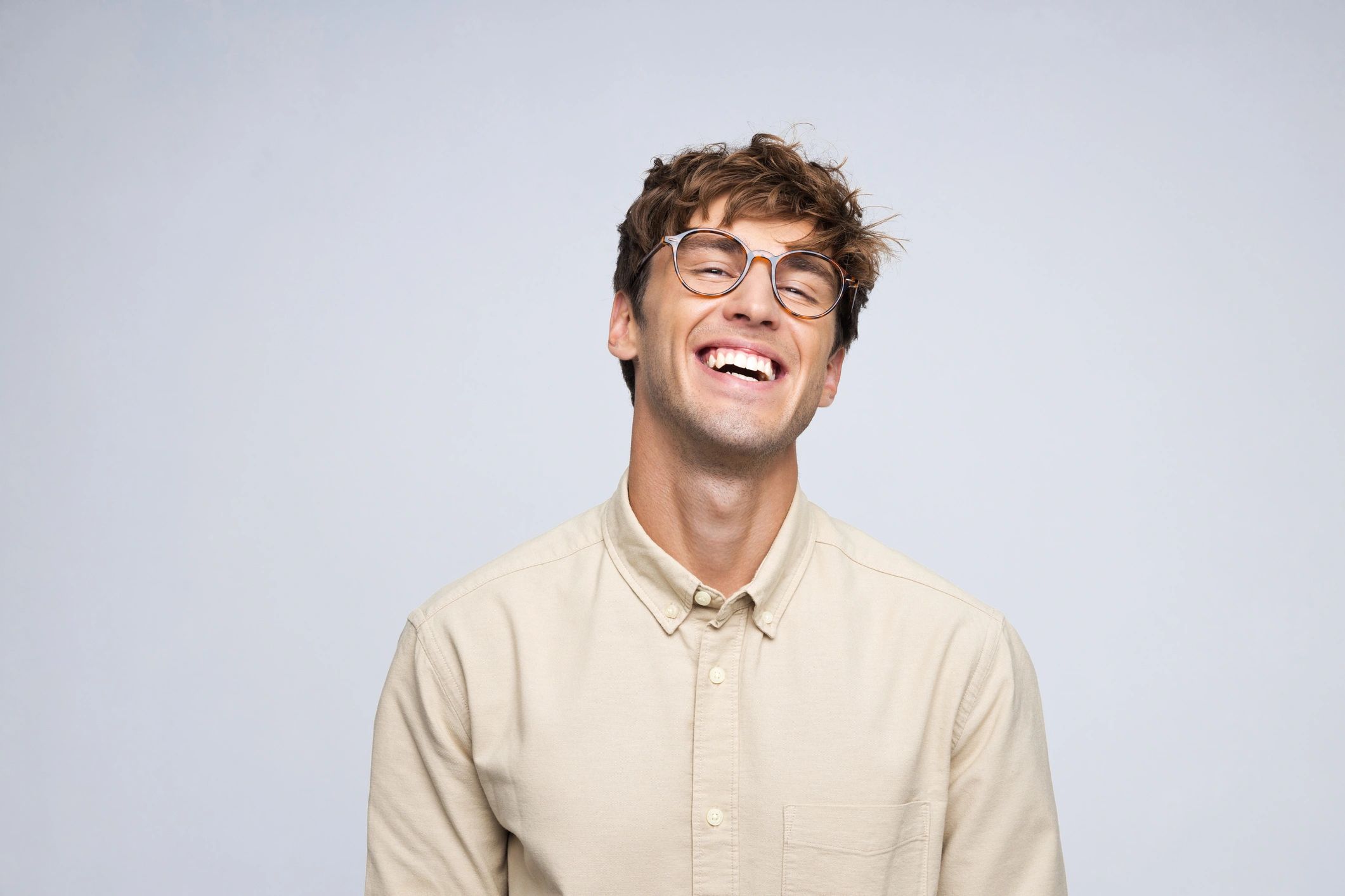 Smiling young adult suitable for Invisalign treatment